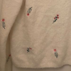 fluffy white sweater with embroidered flowers
